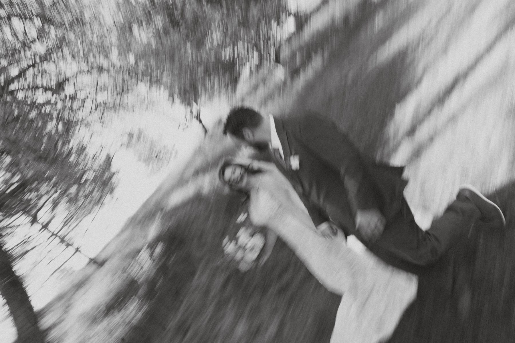 The groom carries her away, motion blur, black and white